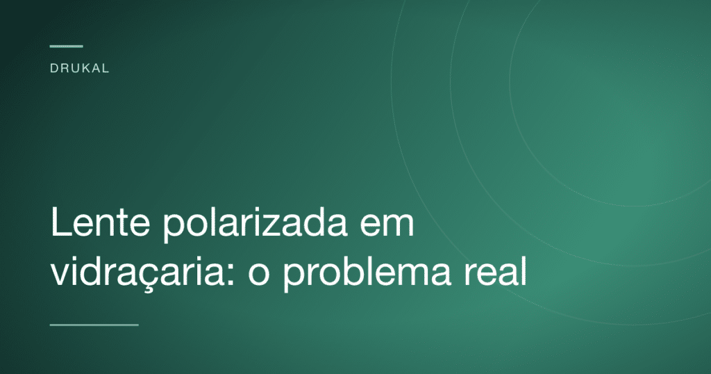 Close de uma lente polarizada sobre uma superfície de vidro mostrando um padrão de faixas coloridas em formato de arco-íris